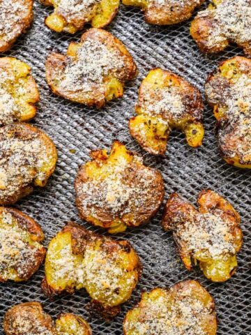 Air fryer smashed potatoes on pan.