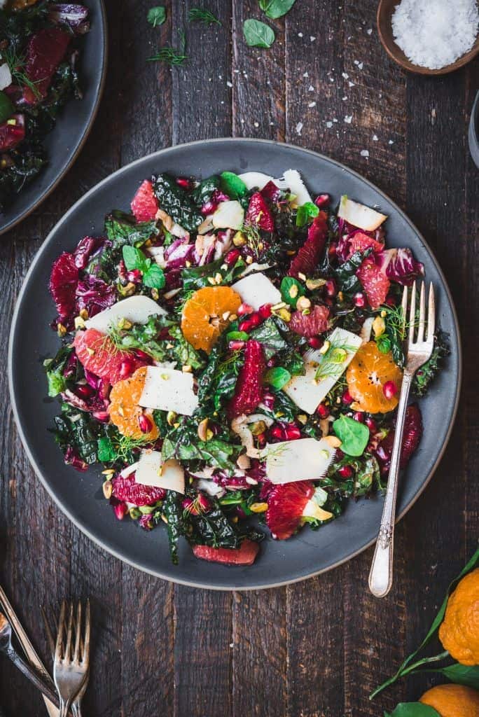 Overhead of kale salad with fresh citrus, parmesan and pistachios