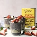 Side view of banana strawberry overnight oats and chia pudding topped with fresh strawberries