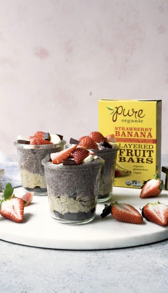 Side view of banana strawberry overnight oats and chia pudding topped with fresh strawberries