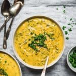 Overhead of Cheesy Vegan Broccoli Soup on linen background