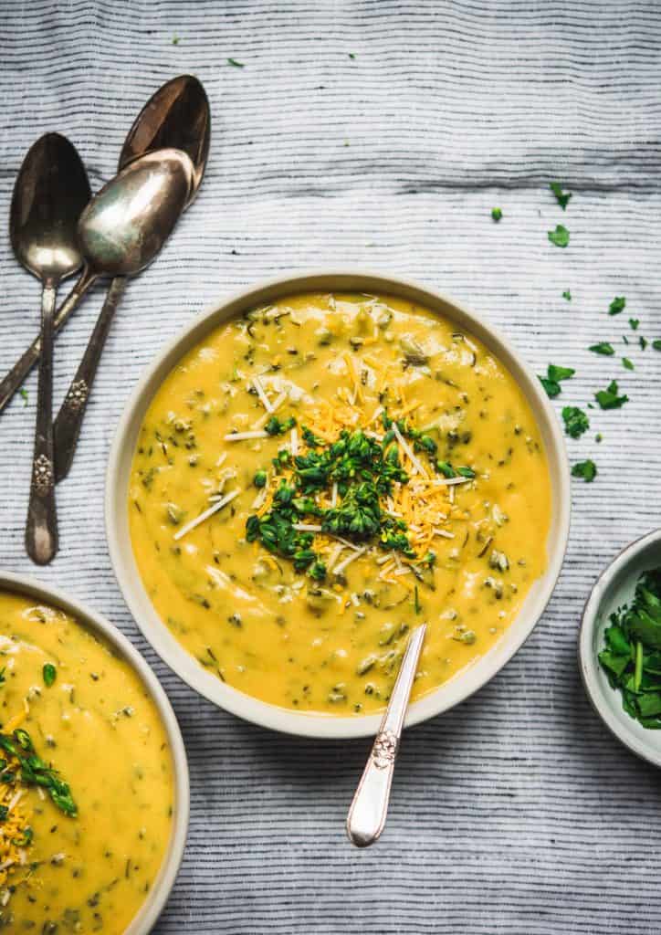 Overhead of Cheesy Vegan Broccoli Soup on linen background