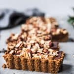 Side view of chocolate hazelnut tart with graham cracker crust