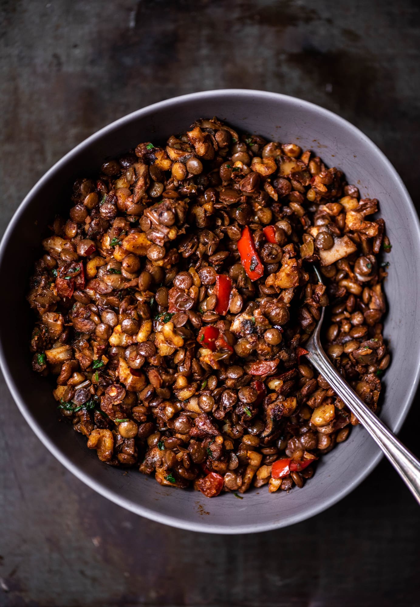 Close up of vegan lentil walnut taco filling in a gray mixing bowl