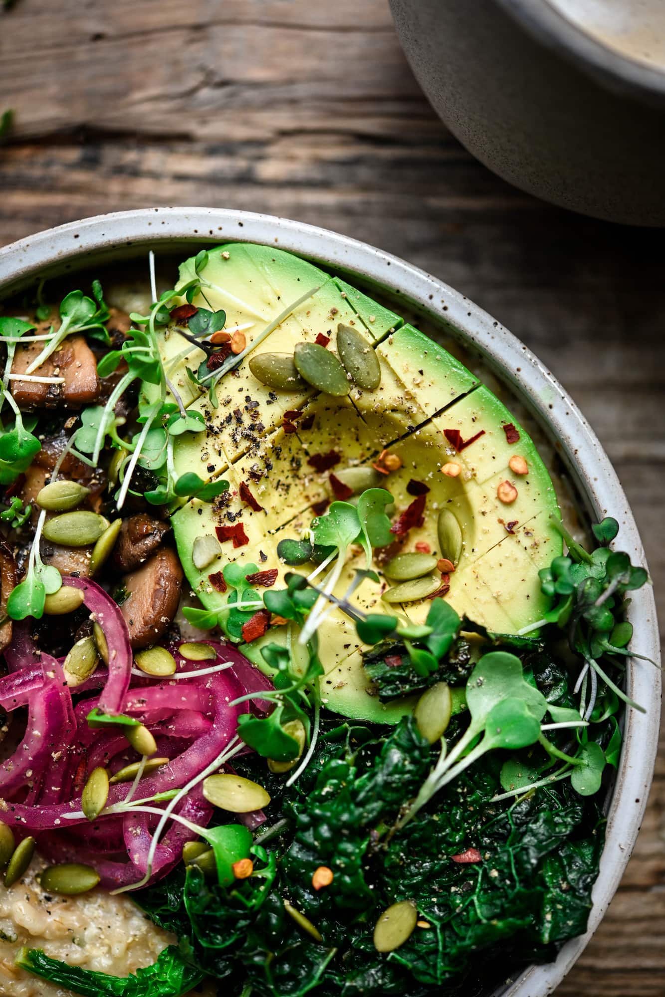 Close up view of vegan avocado in a bowl of savory oatmeal