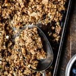 Overhead view of gluten free granola on a sheet pan, close up view of granola in a scoop