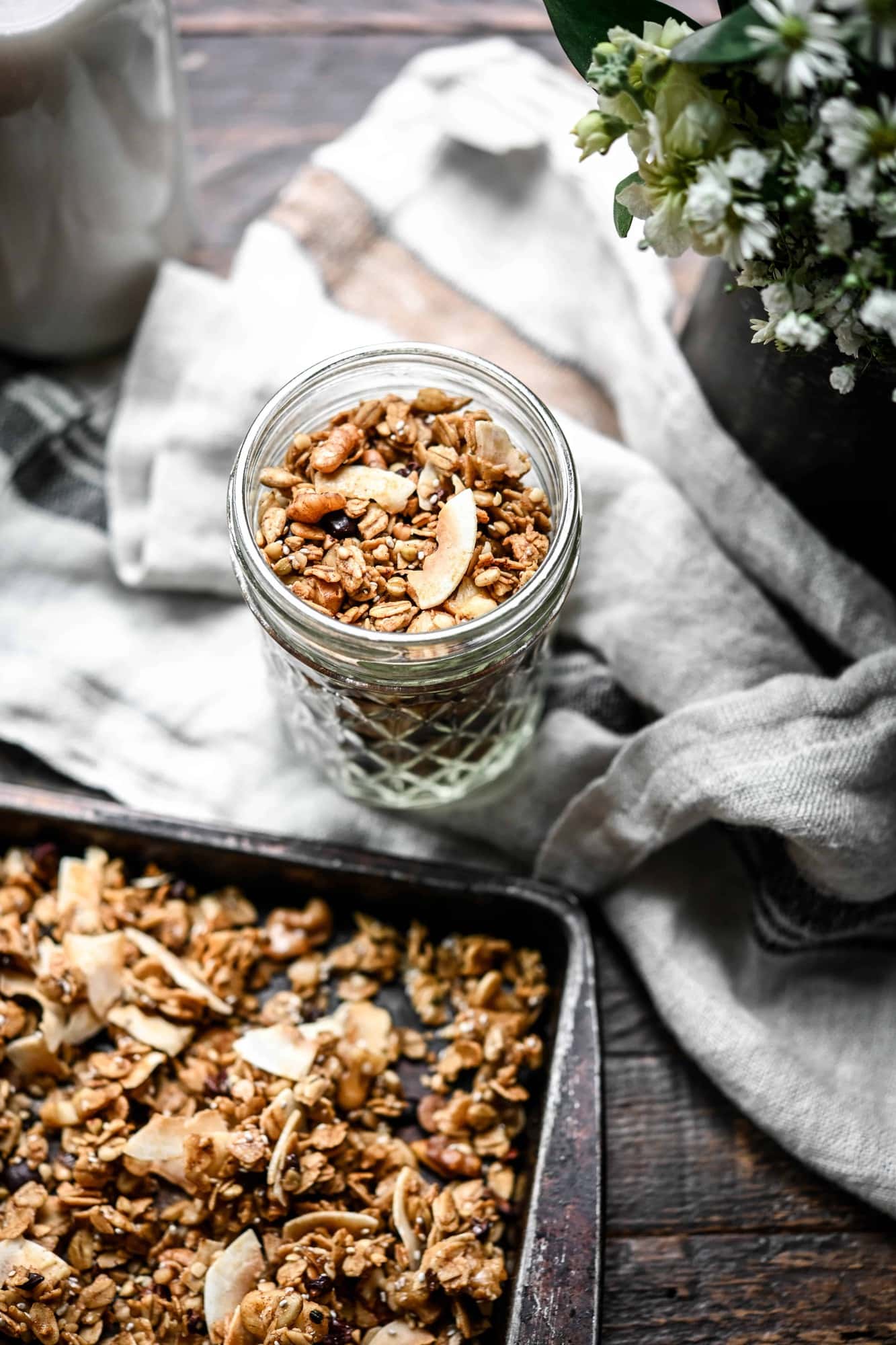 Overhead view of small glass jar filled with gluten free caramel granola