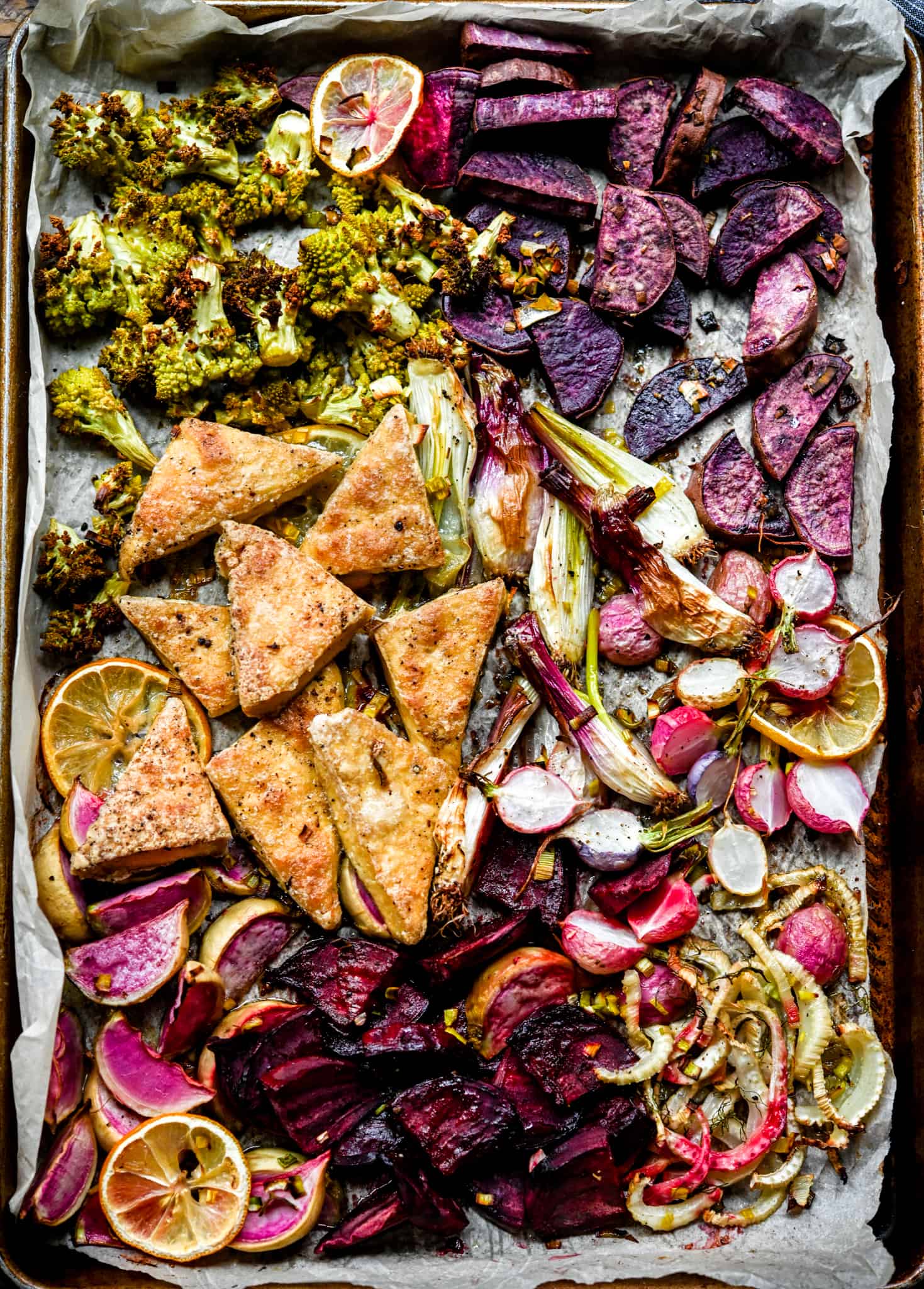 Overhead of sheet pan with purple, pink and green vegetables and tofu