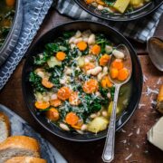 Overhead view of white bean and kale soup in a bowl.