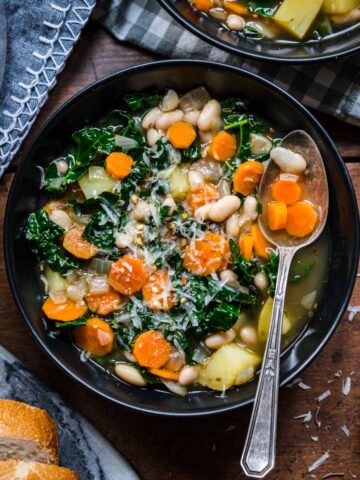 Overhead view of white bean and kale soup in a bowl.