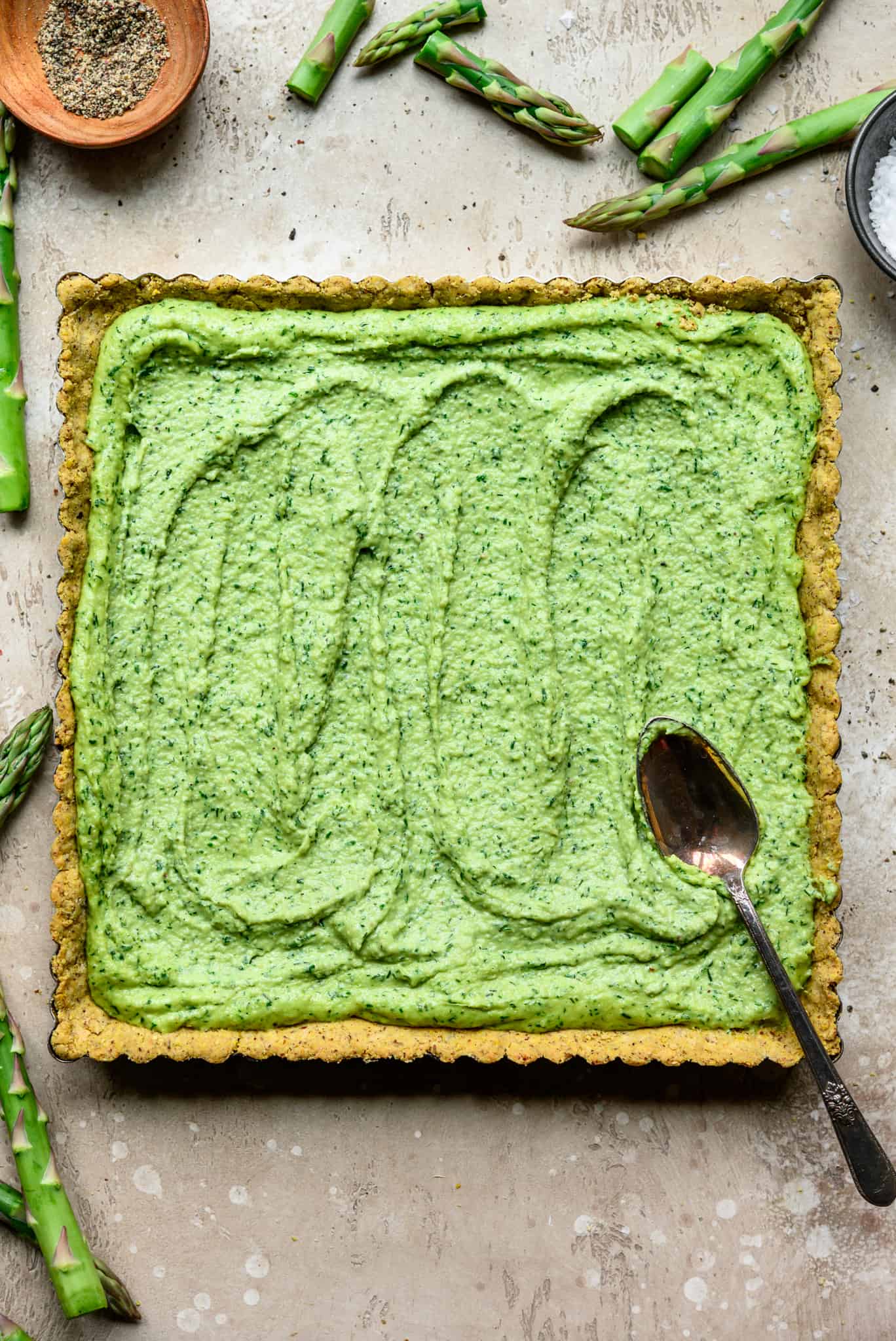 Overhead view of square tart with vegan ricotta filling and spoon