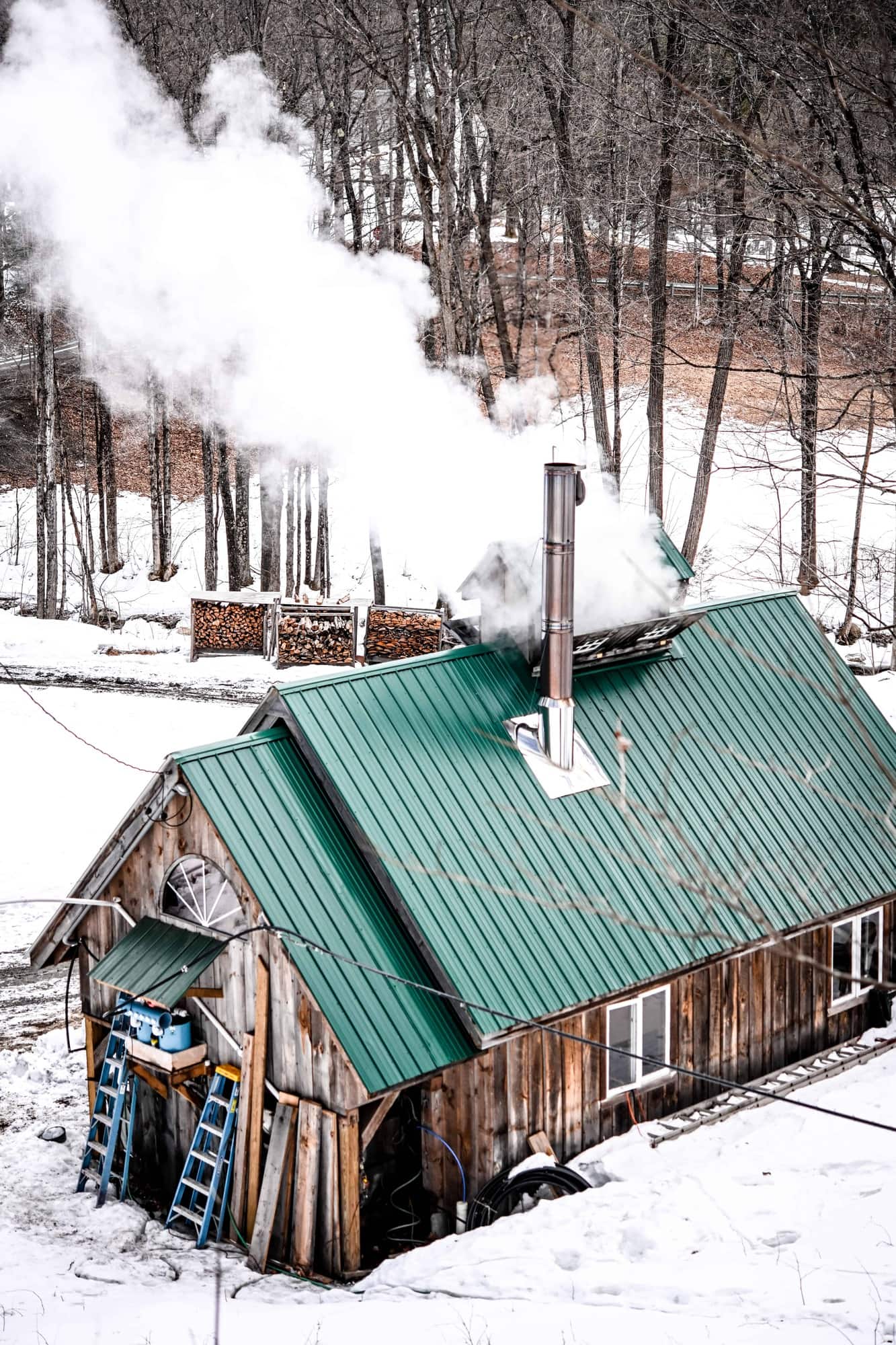 Back view of a Vermont Sugarhouse with steam coming from roof in winter