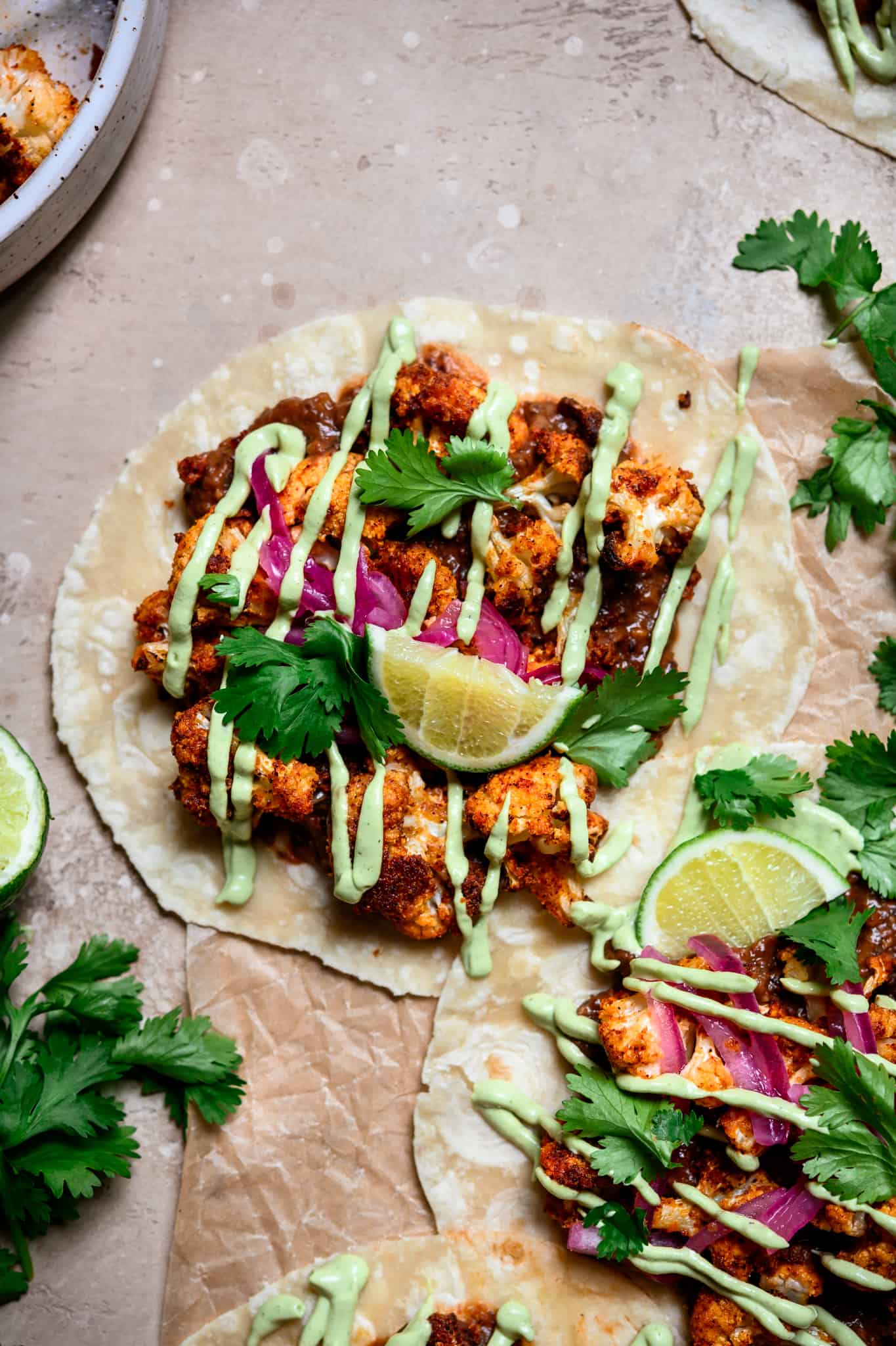 overhead view of tacos with roasted cauliflower and black beans