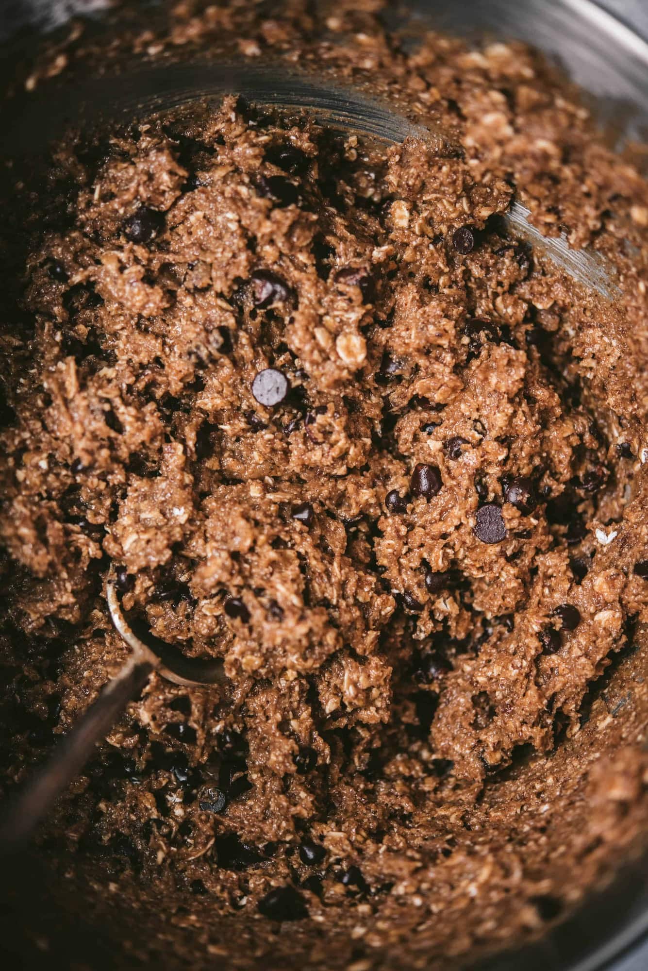 Chocolate chip oatmeal cookie dough in a mixing bowl