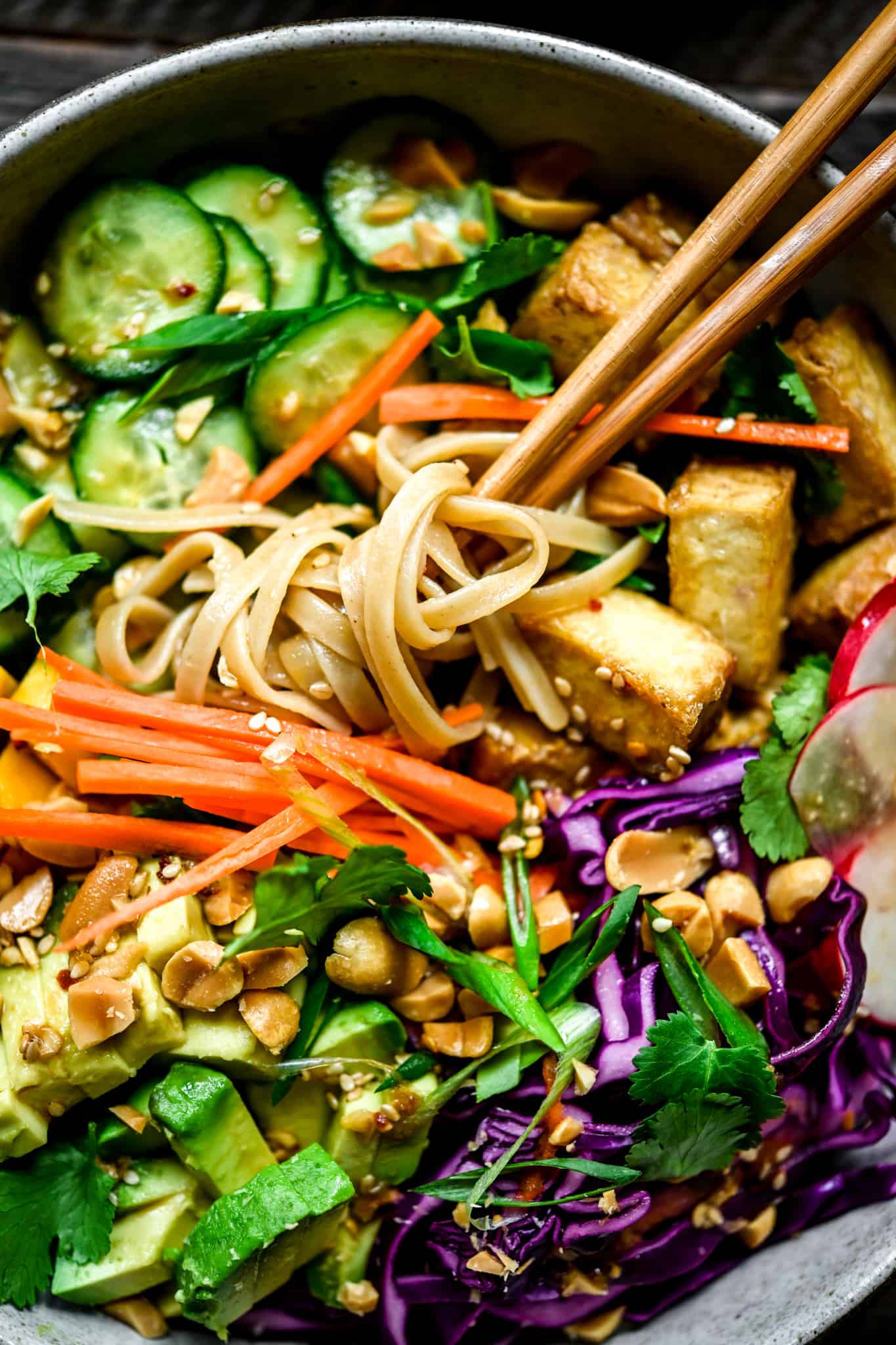 Overhead view of chopsticks and rice noodles with asian vegetables