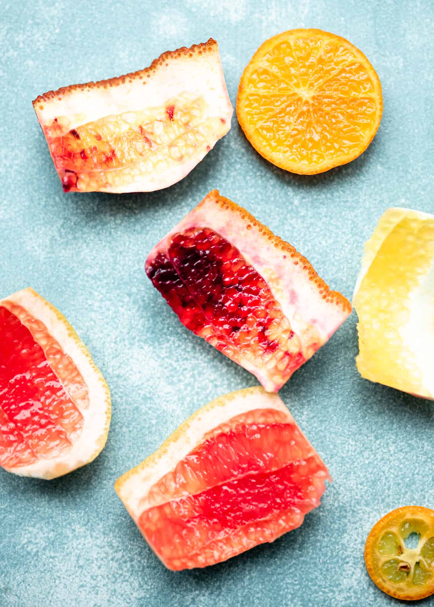 Overhead view of citrus peels on blue background