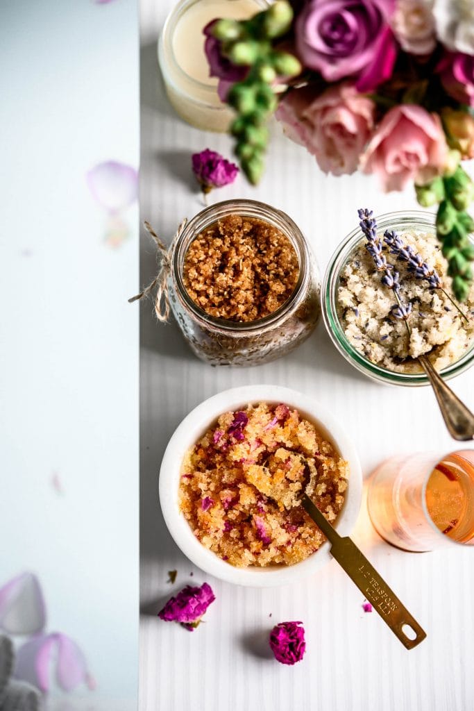 Overhead view of 3 DIY body scrubs above bathtub