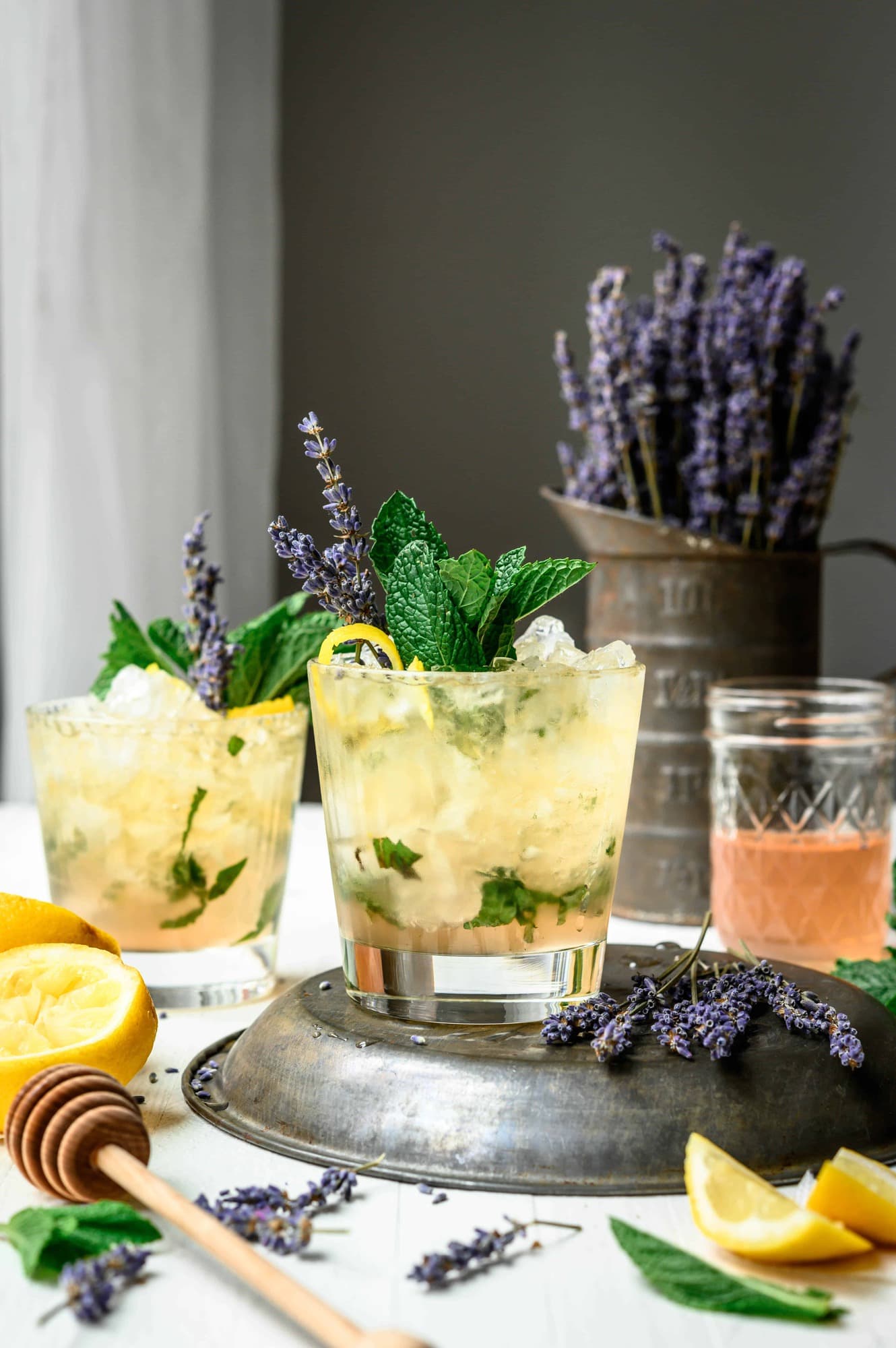 Side view of lemon lavender mint julep on white table