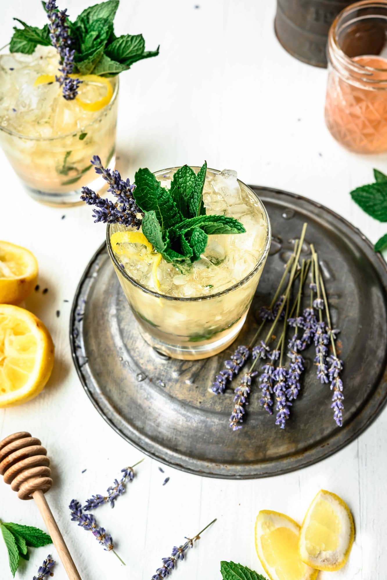 High side view of lemon lavender mint julep garnished with fresh mint, lavender and lemon peel