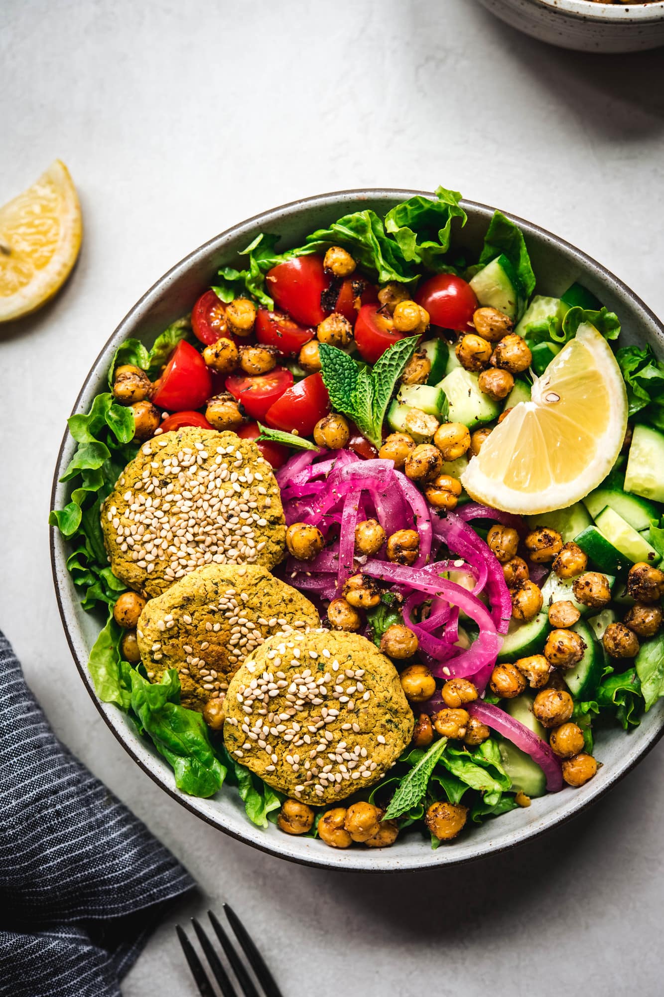 Overhead view of colorful mediterranean salad in a bowl on white background