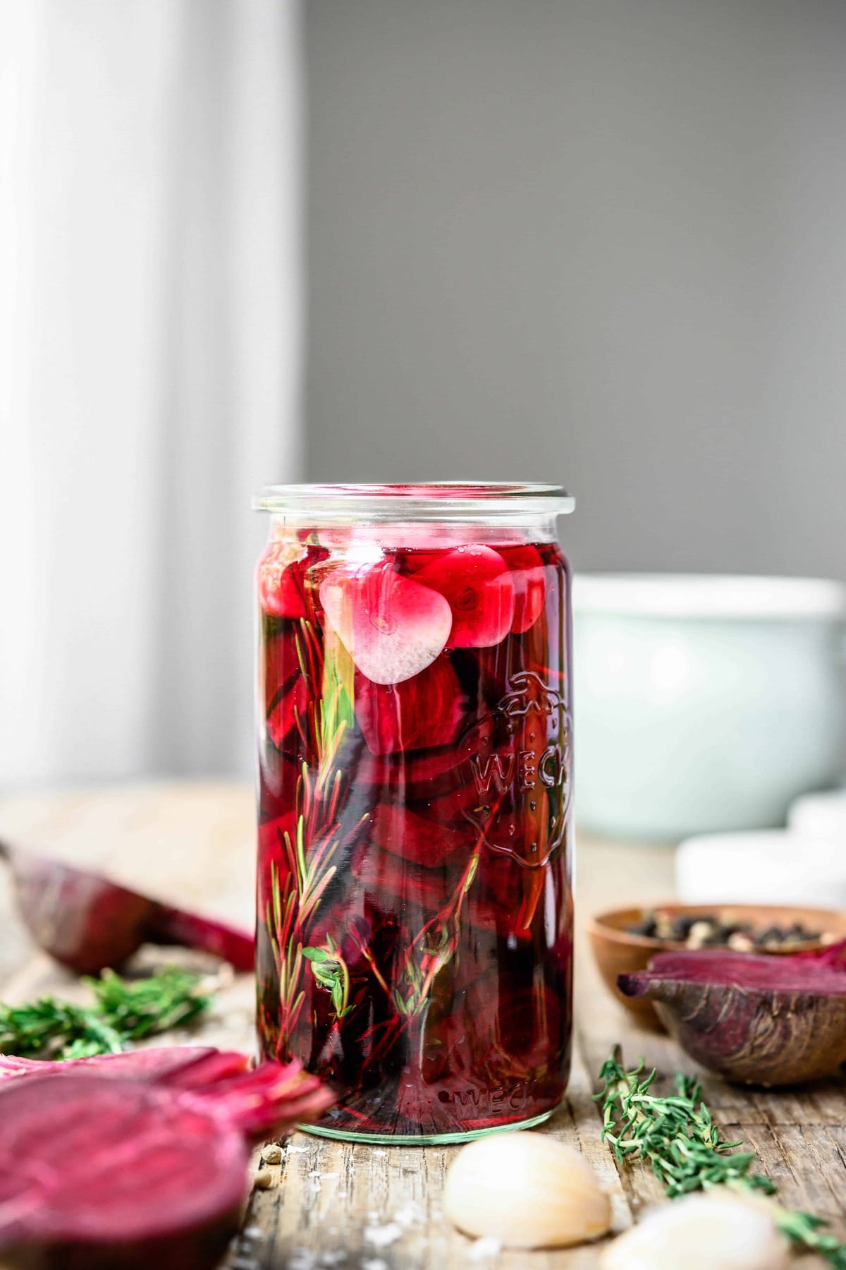 Side view of garlic rosemary pickled beets on wood table