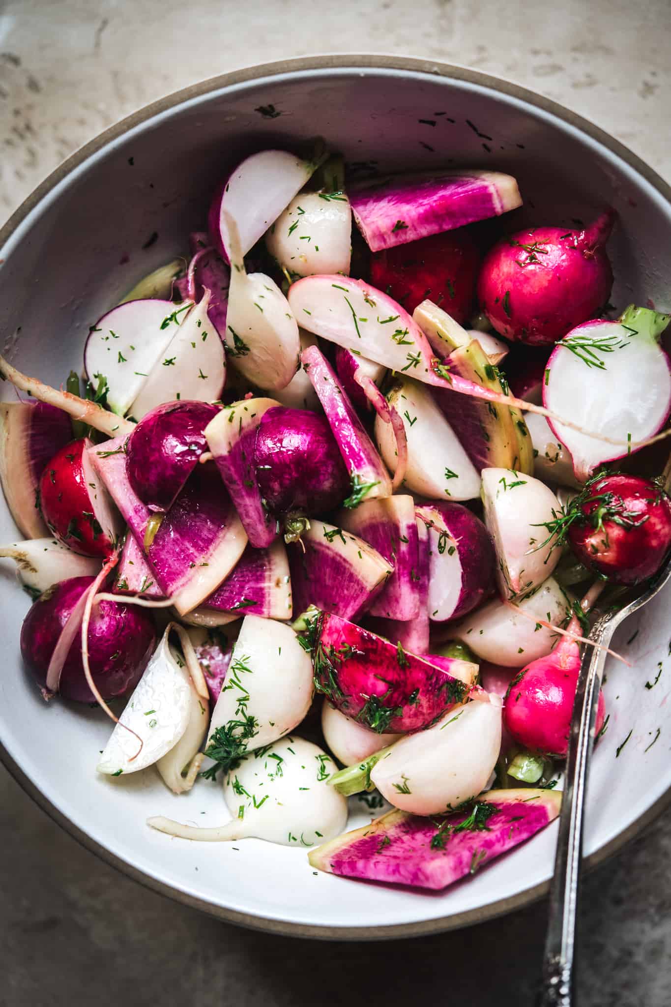 overhead view of radishes in bowl