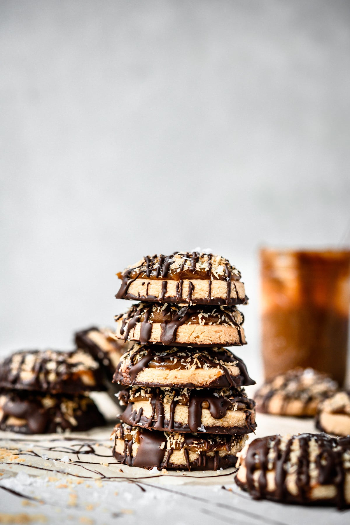 Side view of stack of gluten free vegan Samoa cookies on white background