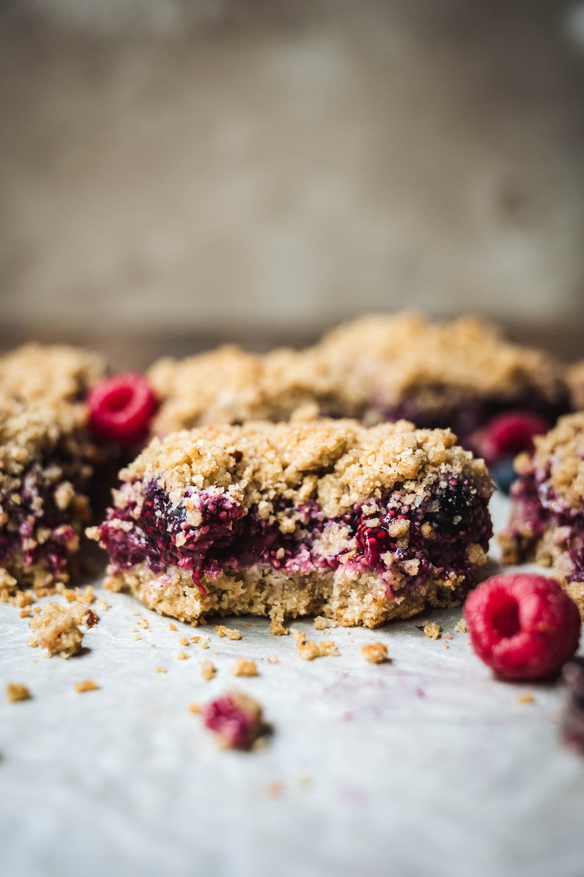 Vegan, gluten free four berry pie bars with a bite taken out