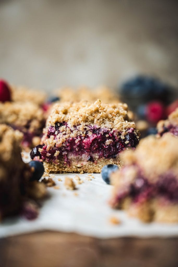 Side view of four berry pie bar with streusel topping