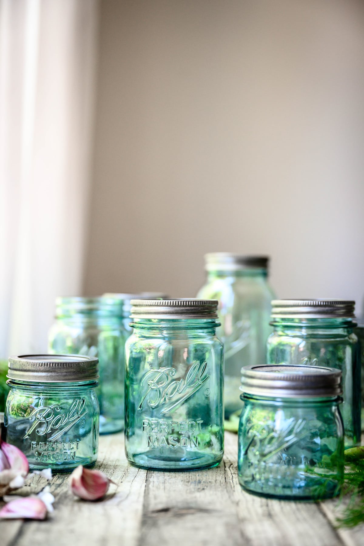 Side view of blue vintage Ball jars on a wood table