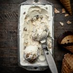 Overhead view of vegan cookie dough ice cream in antique pan with scoop