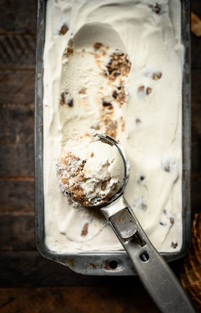 Close up view of scoop of cookie dough ice cream with antique scooper