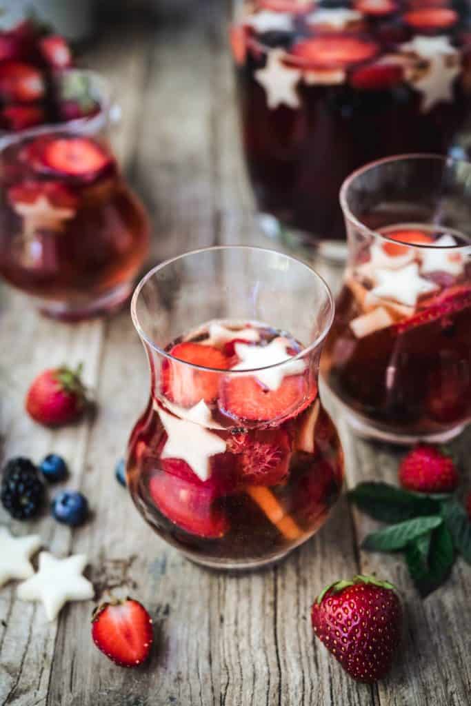 45 degree angle of red white and blue sangria with berries in glasses