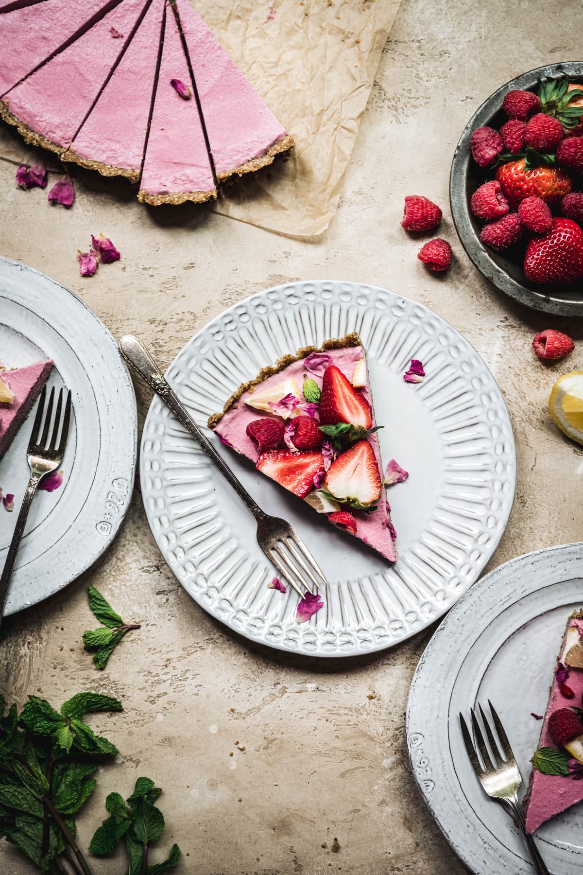 Overhead view of slice of vegan strawberry mousse pie on a white plate
