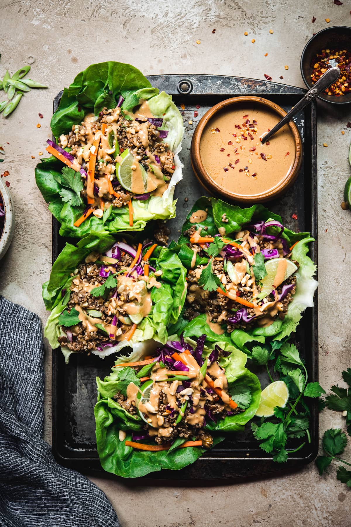 Overhead view of vegan asian lettuce wraps with lentil walnut filling and peanut sauce on antique tray