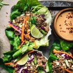 Close up Overhead view of vegan asian lettuce wraps with lentil walnut filling and peanut sauce on antique tray