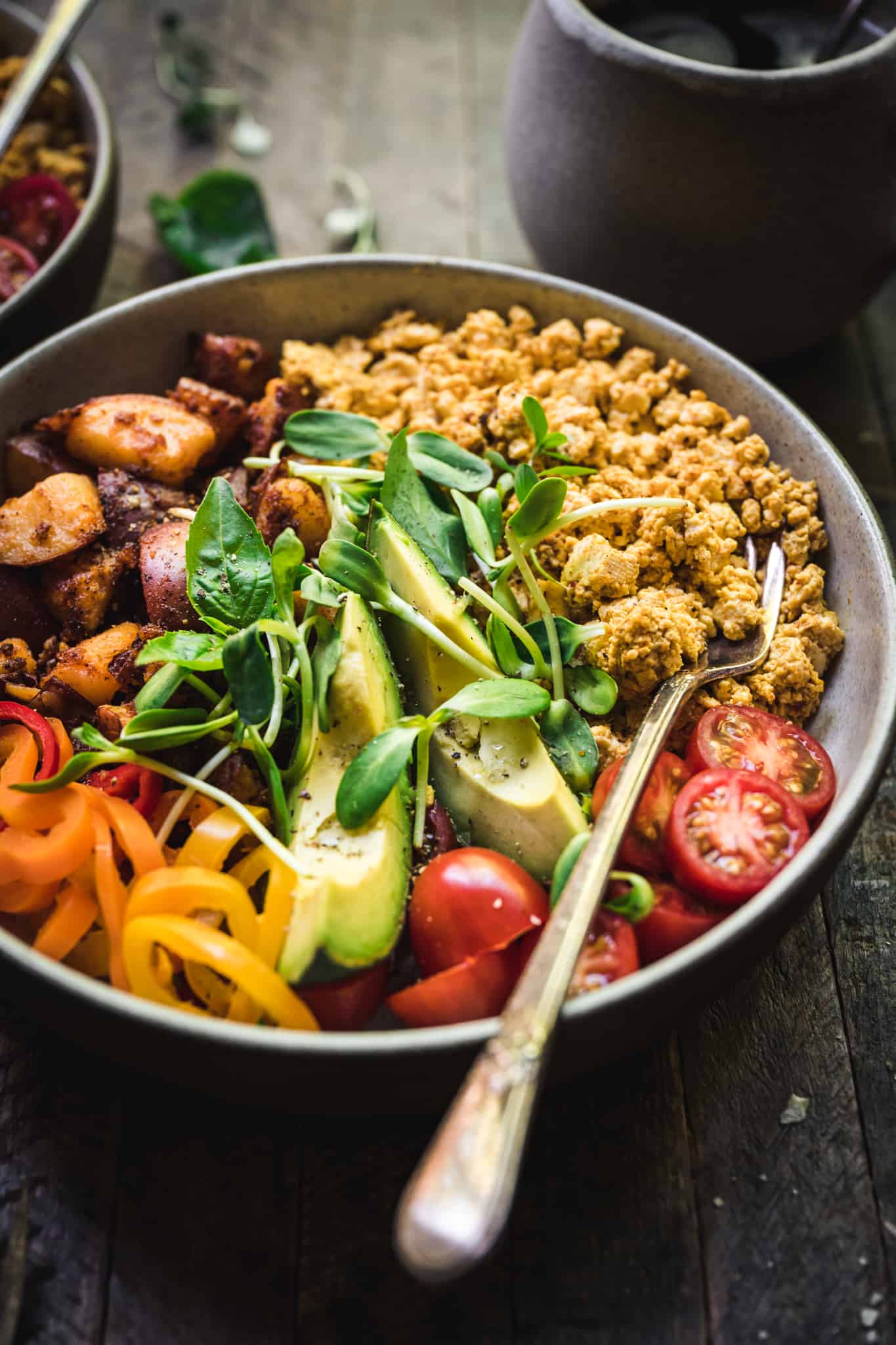 45 degree angle of high protein breakfast bowls with scrambled tofu and spicy potatoes