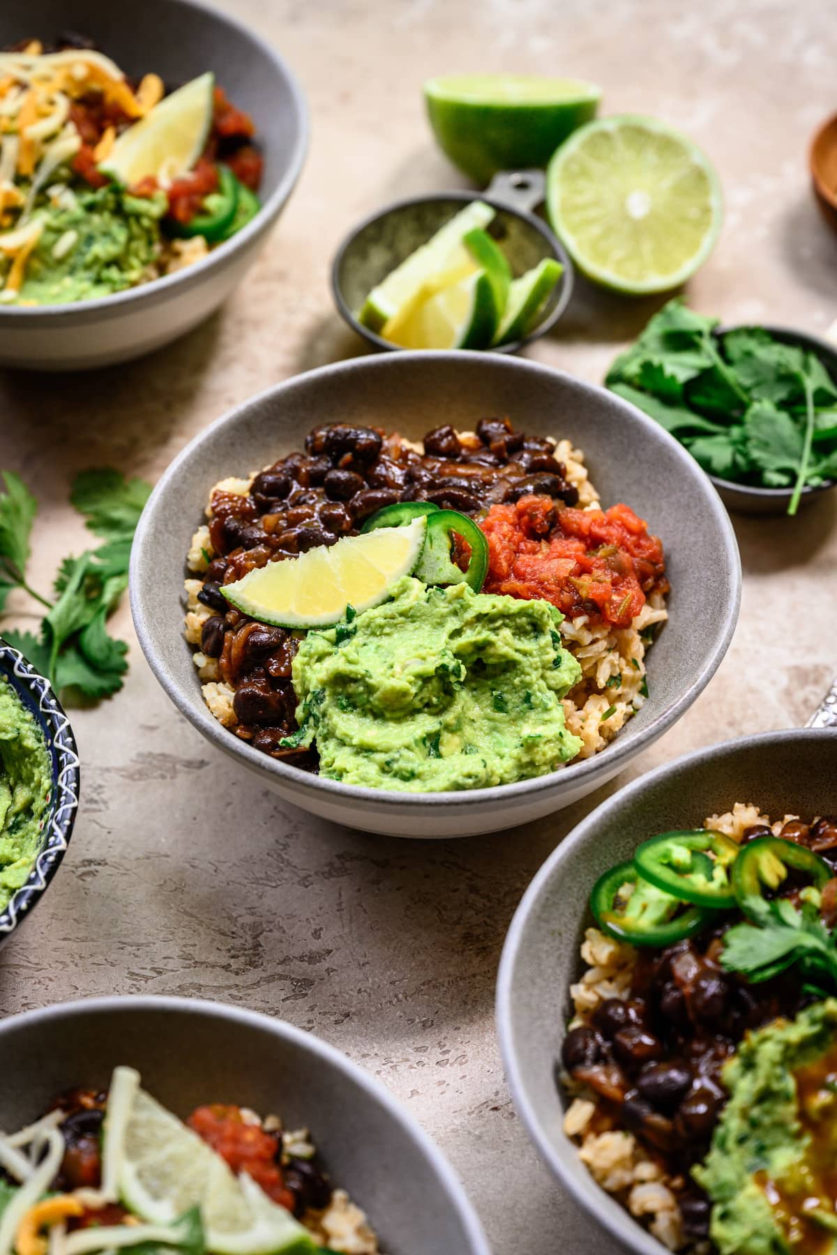 Side view of vegan burrito bowls with spicy black beans and guacamole