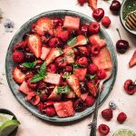 Watermelon berry salad with mint lime dressing in a bowl