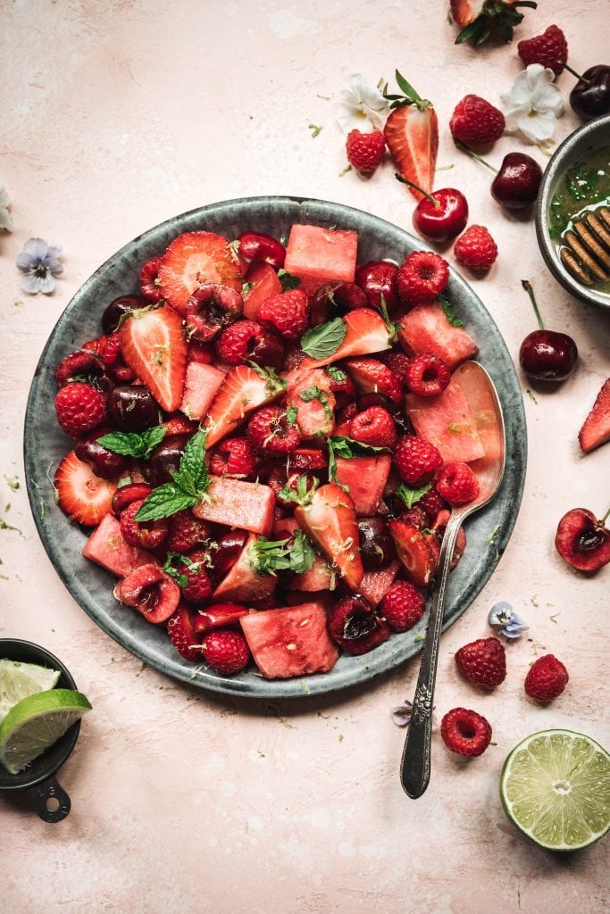 Watermelon berry salad with mint lime dressing in a bowl