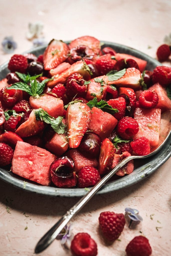 45 degree angle of watermelon berry salad with mint lime dressing