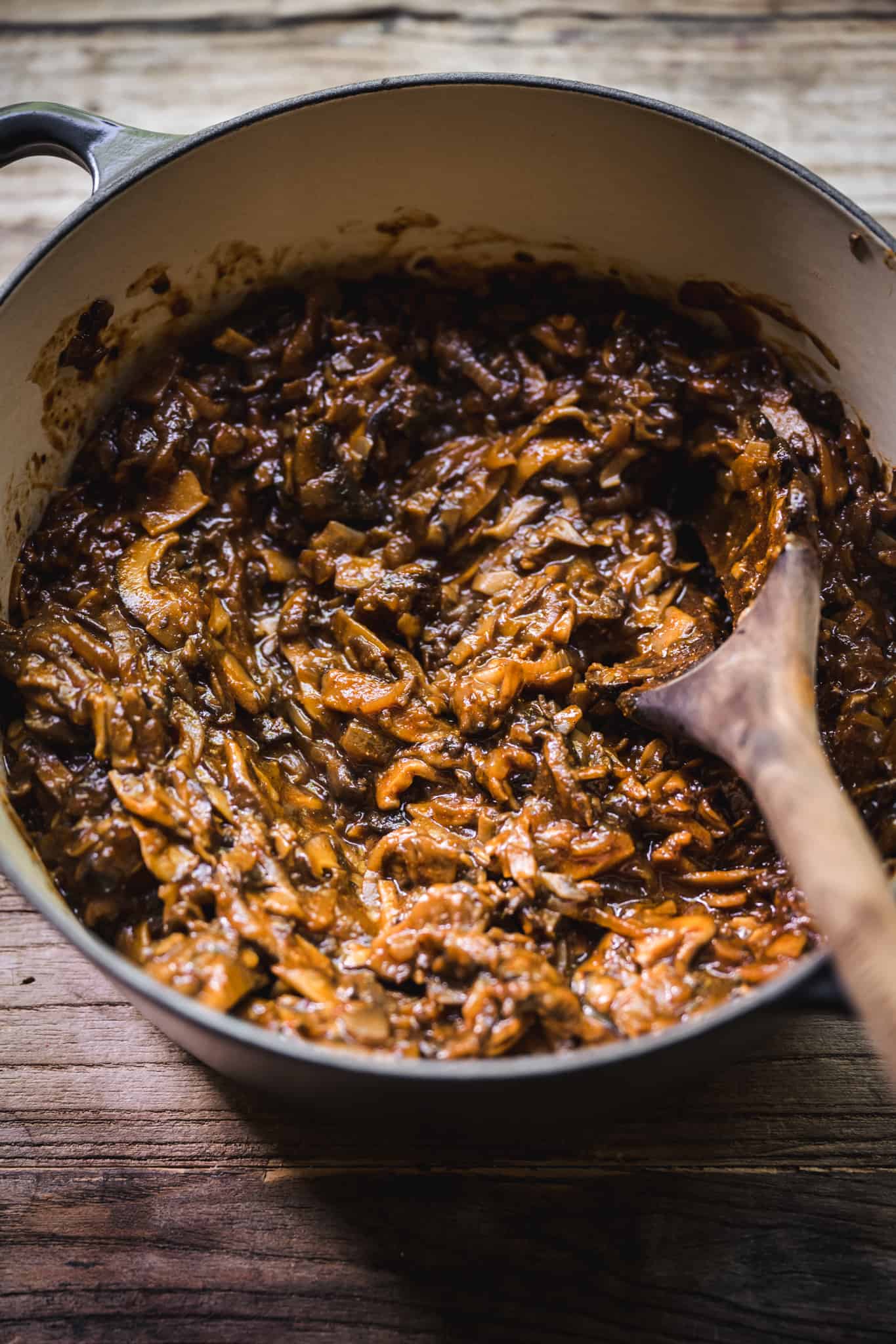 Side view of pulled bbq mushrooms in a cast iron pot