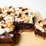 Side view of vegan and gluten free s'mores brownies on parchment paper