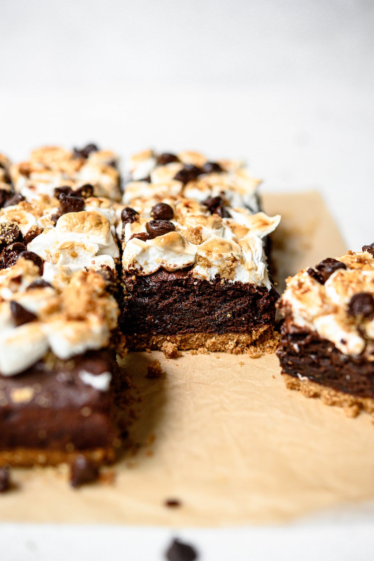 Side view of vegan and gluten free s'mores brownies on parchment paper