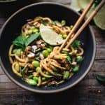 overhead of red curry almond butter zucchini noodles with chopsticks