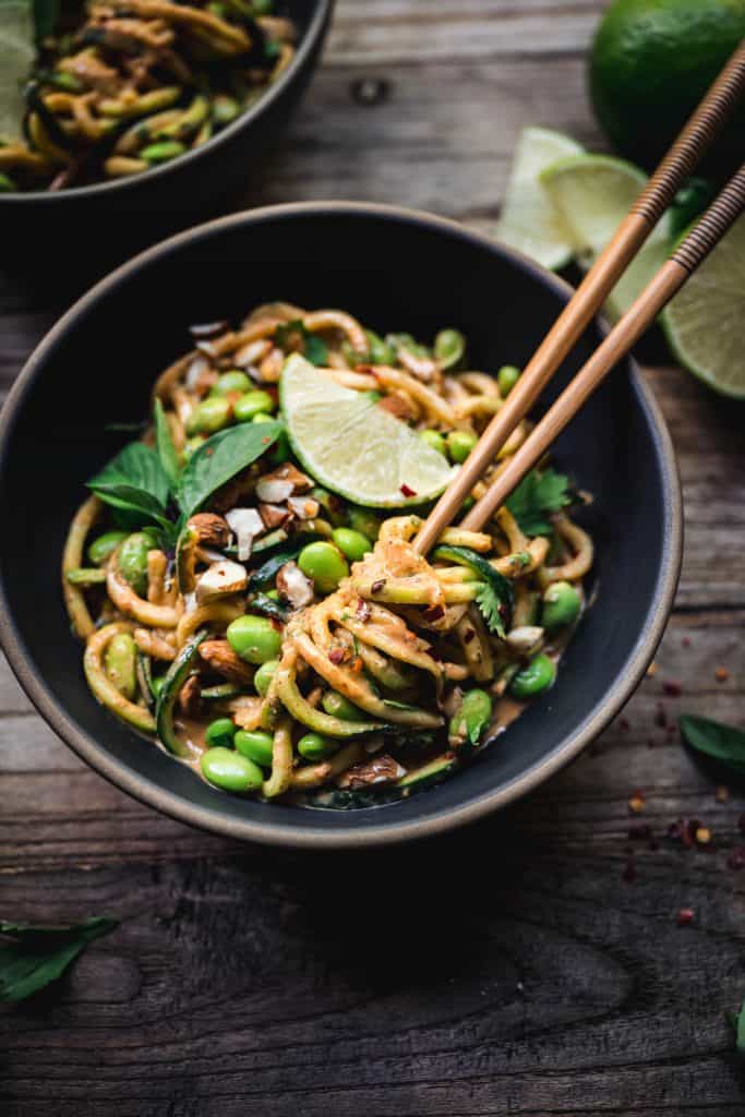 overhead of red curry almond butter zucchini noodles with chopsticks