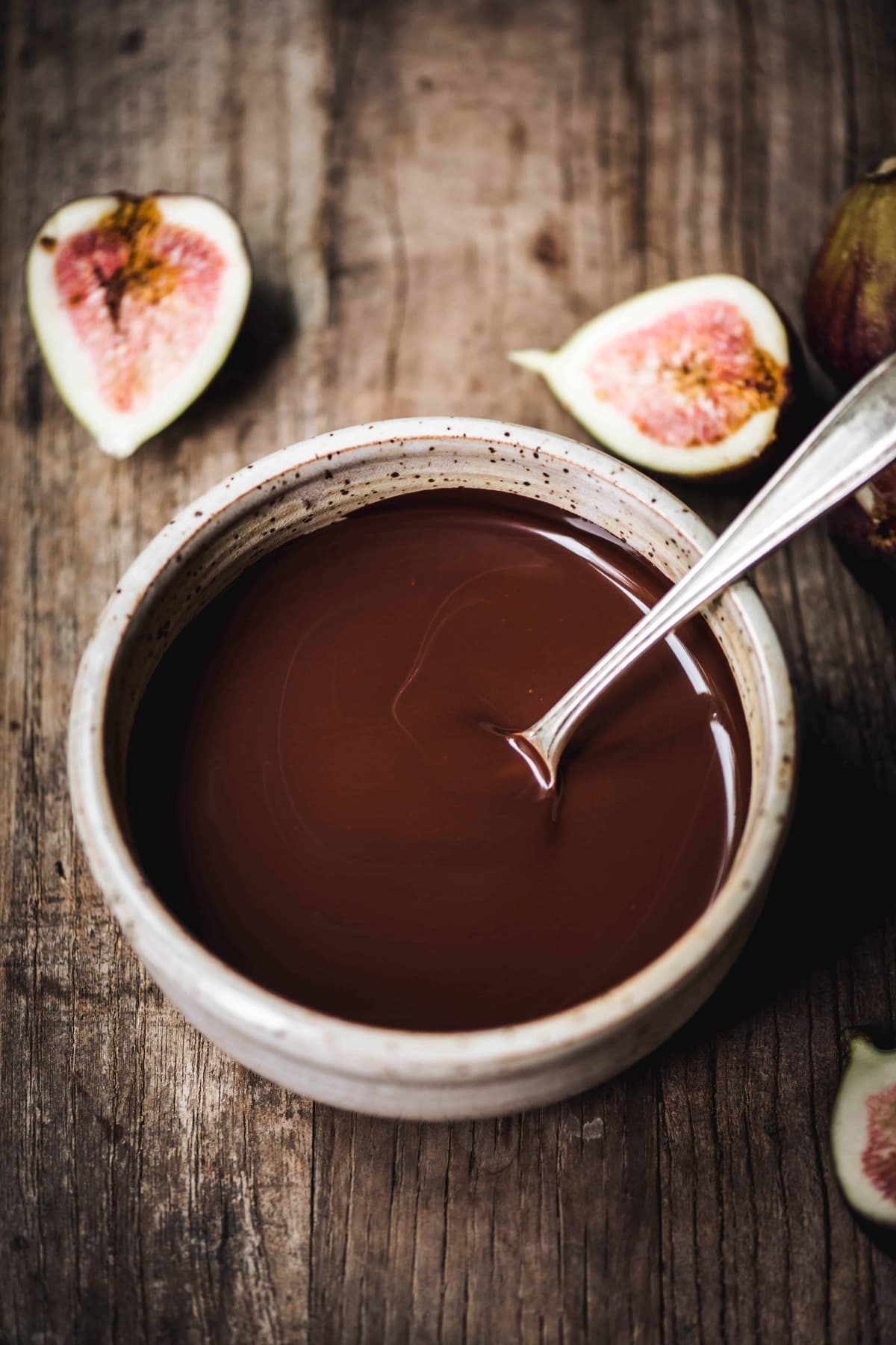 High side view of melted dark chocolate in a bowl