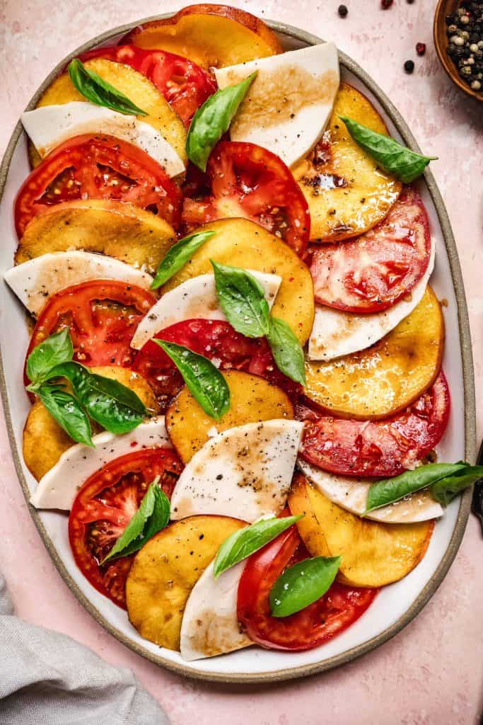 overhead of layered vegan grilled peach caprese salad