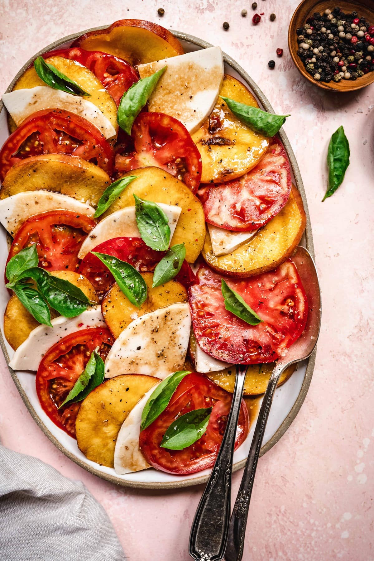 overhead of grilled peach caprese salad with vegan cheese and balsamic dressing