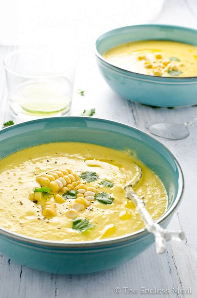 45 degree angle of vegan sweet corn gazpacho in a blue bowl